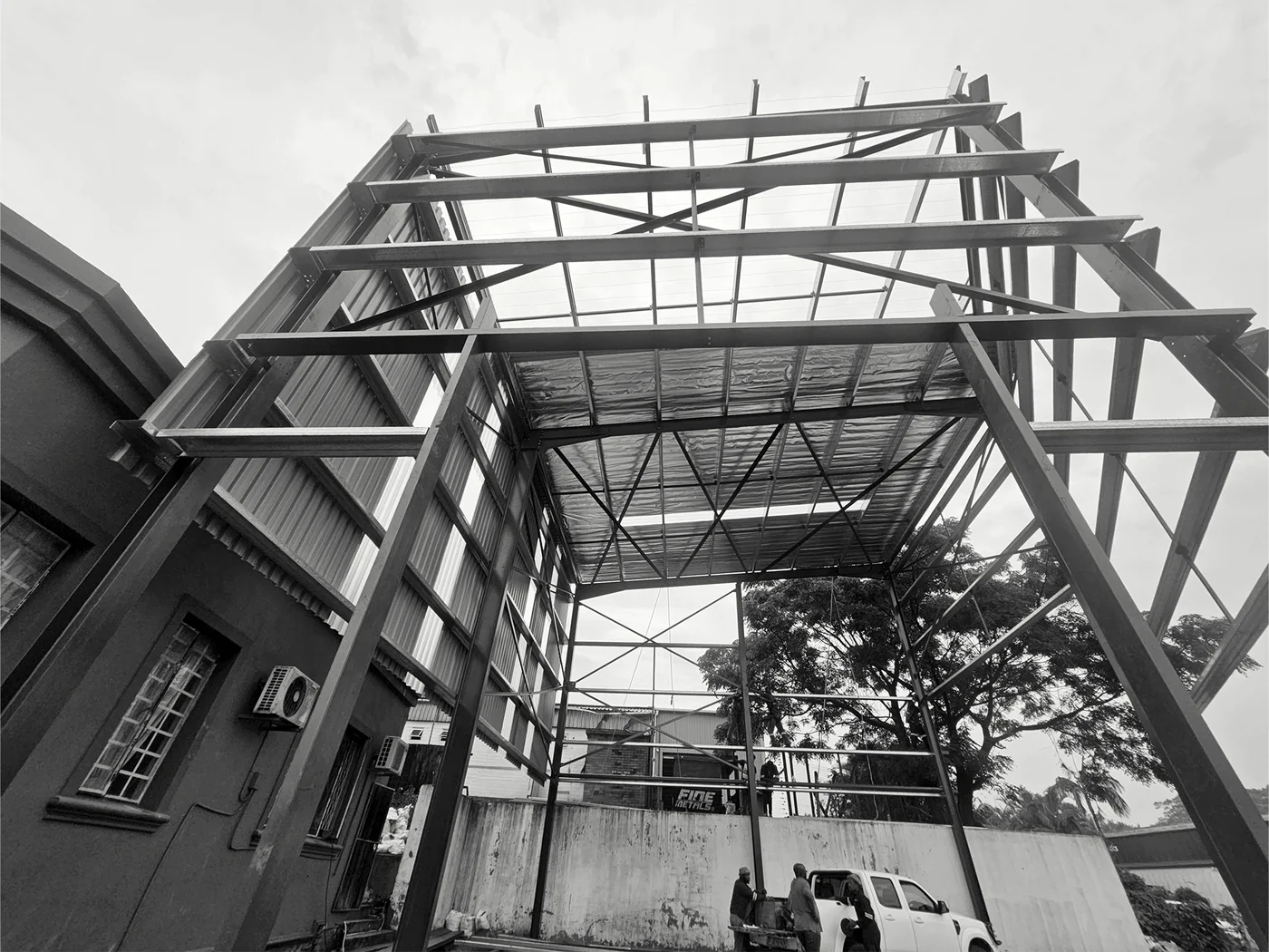 Structural-steel framing erected alongside existing construction